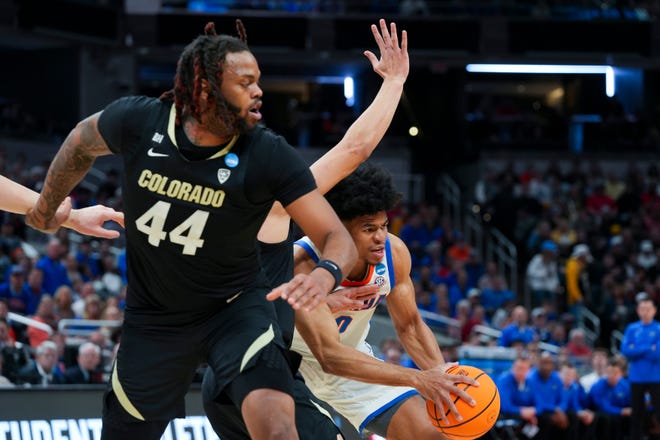Florida Gators guard Zyon Pullin (0) drives the lane while Colorado Buffaloes players defend him on Friday, March 22, 2024, during the first round of the NCAA Men’s Basketball Tournament at Gainbridge Fieldhouse in Indianapolis. Florida Gators and Colorado Buffaloes are tied 45-45 at halftime.