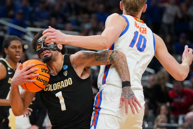 Colorado Buffaloes guard J'Vonne Hadley (1) drives the lane past Florida Gators forward Thomas Haugh (10) on Friday, March 22, 2024, during the first round of the NCAA Men’s Basketball Tournament at Gainbridge Fieldhouse in Indianapolis. The Colorado Buffaloes defeated the Florida Gators 102-100.