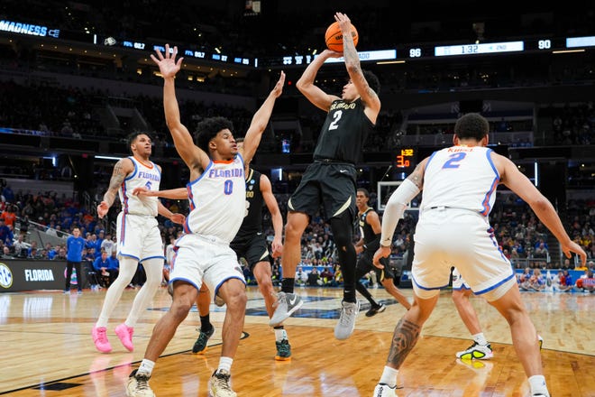 Colorado Buffaloes guard KJ Simpson (2) shoots a field goal over Florida Gators guard Zyon Pullin (0) on Friday, March 22, 2024, during the first round of the NCAA Men’s Basketball Tournament at Gainbridge Fieldhouse in Indianapolis. The Colorado Buffaloes defeated the Florida Gators 102-100.