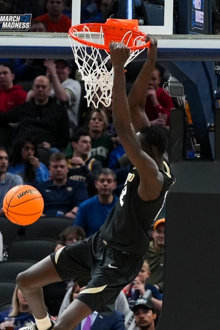 Colorado Buffaloes forward Bangot Dak (12) dunks the ball Friday, March 22, 2024, during the first round of the NCAA Men’s Basketball Tournament at Gainbridge Fieldhouse in Indianapolis. Florida Gators and Colorado Buffaloes are tied 45-45 at halftime.