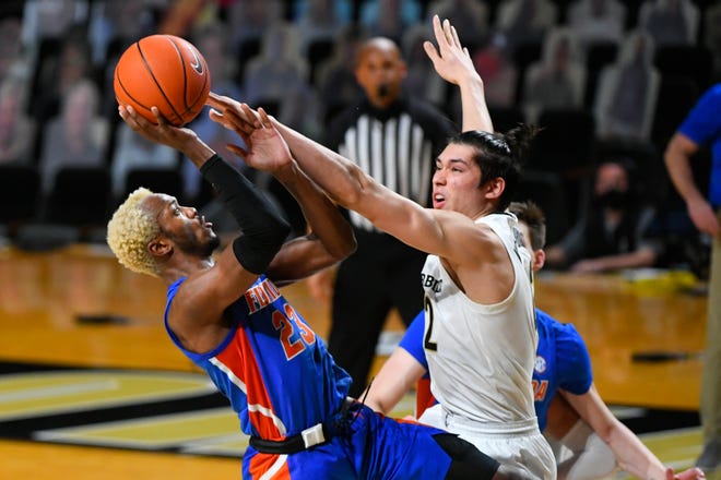 Florida guard Scottie Lewis shoots as Vanderbilt forward Quentin Millora-Brown, right, defends during the second half of an NCAA college basketball game Wednesday, Dec. 30, 2020, in Nashville, Tenn. Florida won 91-72. (AP Photo/John Amis)