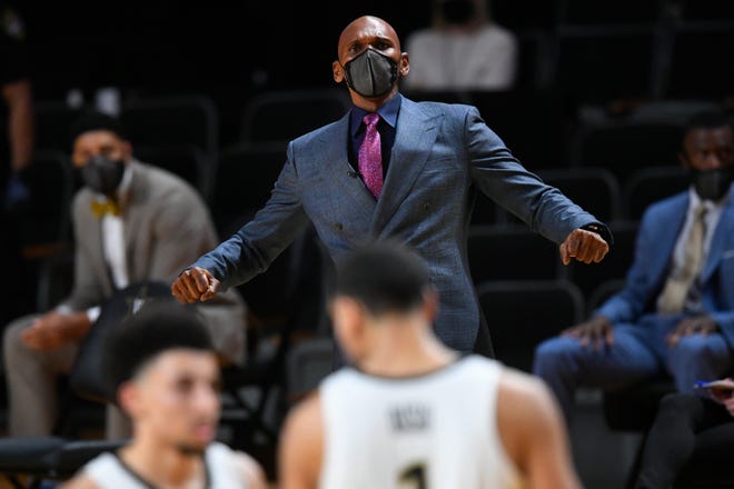 Vanderbilt coach Jerry Stackhouse tries to get the attention of players during the second half of the team's NCAA college basketball game against Florida, Wednesday, Dec. 30, 2020, in Nashville, Tenn. (AP Photo/John Amis)