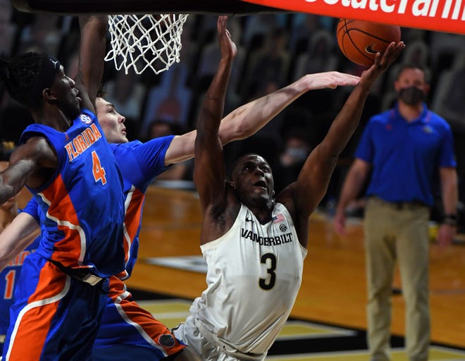 Dec 30, 2020; Nashville, Tennessee, USA; Vanderbilt Commodores guard Maxwell Evans (3) is fouled by Florida Gators forward Colin Castleton (12) during the first half at Memorial Gymnasium. Mandatory Credit: Christopher Hanewinckel-USA TODAY Sports