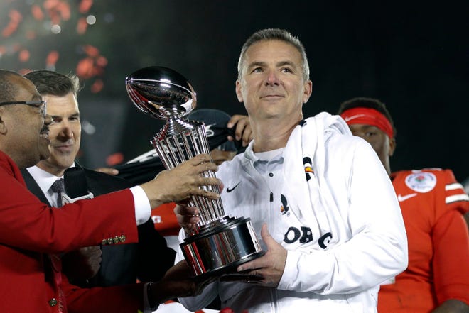 Urban Meyer as Ohio State coach holds the trophy after the team's 28-23 win over Washington in the Rose Bowl after the 2018 season.