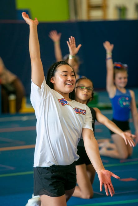 Team member Leanne Wong teaches a floor exercise as the University of Florida gymnastics team put on a gymnastics clinic at Balance 180 gymnastics Gainesville, FL on Saturday, March 25, 2023. More than 100 young gymnasts learned gymnastics training and routines. They also  met the gymnasts to get autographs and pictures at the NIL Gatorverse event. [Alan Youngblood/Gainesville Sun]