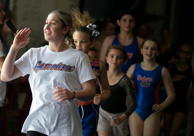Team member Payton Richards leads warm ups as the University of Florida gymnastics team put on a gymnastics clinic at Balance 180 gymnastics Gainesville, FL on Saturday, March 25, 2023. More than 100 young gymnasts learned gymnastics training and routines. They also  met the gymnasts to get autographs and pictures at the NIL Gatorverse event. [Alan Youngblood/Gainesville Sun]