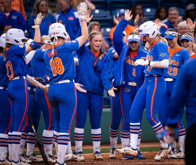 Florida infielder Skylar Wallace (17) is greeted at home plate by teammates after hitting a home run and driving in a run to make it 6-0 in the bottom of the 4th. The Florida women’s softball team hosted Stetson at Katie Seashole Pressly Stadium in Gainesville, FL on Wednesday, March 29, 2023. Florida won 8-0 in six. [Doug Engle/Gainesville Sun]