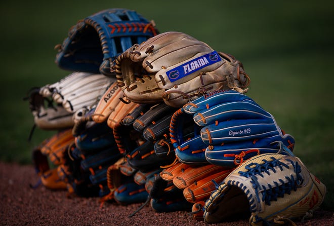 Florida gloves were stacked before the game Wednesday. The Florida women’s softball team hosted Stetson at Katie Seashole Pressly Stadium in Gainesville, FL on Wednesday, March 29, 2023. Florida won 8-0 in six. [Doug Engle/Gainesville Sun]
