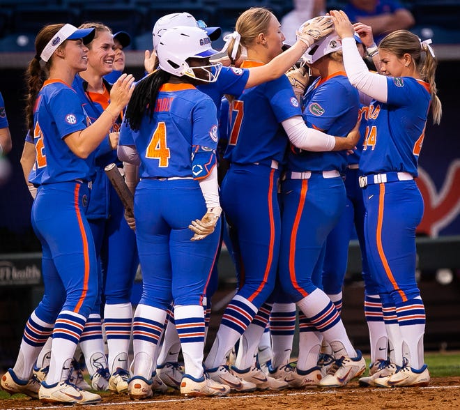 Florida teammates congratulate Florida infielder Reagan Walsh (15) after she drove in a run in the bottom of the 6th ending the game 8-0. The Florida women’s softball team hosted Stetson at Katie Seashole Pressly Stadium in Gainesville, FL on Wednesday, March 29, 2023. Florida won 8-0 in six. [Doug Engle/Gainesville Sun]