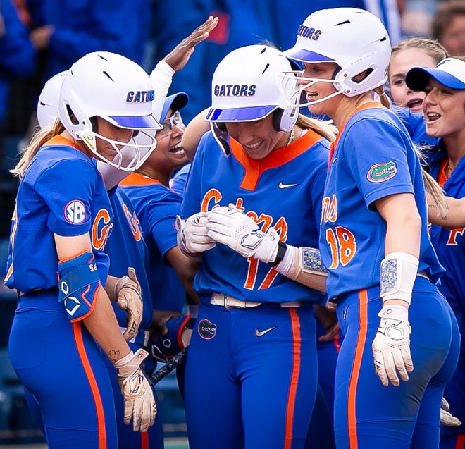 Florida infielder Skylar Wallace (17) is greeted at home plate by teammates after hitting a home run and driving in a run to make it 6-0 in the bottom of the 4th. The Florida women’s softball team hosted Stetson at Katie Seashole Pressly Stadium in Gainesville, FL on Wednesday, March 29, 2023. Florida won 8-0 in six. [Doug Engle/Gainesville Sun]