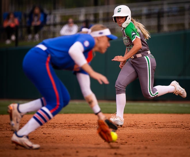 Florida infielder Skylar Wallace (17) fields a ground ball as Stetson utility Briana Robinson (22) makes it to second safe in the top of the second.The Florida women’s softball team hosted Stetson at Katie Seashole Pressly Stadium in Gainesville, FL on Wednesday, March 29, 2023. Florida won 8-0 in six. [Doug Engle/Gainesville Sun]