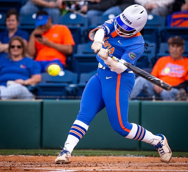Florida third baseman Charla Echols (4) hits a solo home run in the bottom of the first. The Florida women’s softball team hosted Stetson at Katie Seashole Pressly Stadium in Gainesville, FL on Wednesday, March 29, 2023. Florida won 8-0 in six. [Doug Engle/Gainesville Sun]