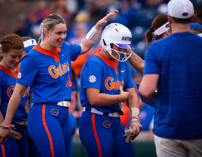 Florida utility Emily Wilkie (18) congratulates Florida infielder Reagan Walsh (15) after hitting a solo home run in the bottom of the second to make it 2-0 Florida. The Florida women’s softball team hosted Stetson at Katie Seashole Pressly Stadium in Gainesville, FL on Wednesday, March 29, 2023. Florida won 8-0 in six. [Doug Engle/Gainesville Sun]