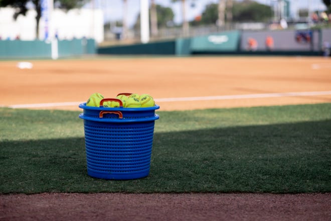 A basket of softballs sits on the field before the game between the Florida Gators and Auburn Tigers during the softball game at Katie Seashole Pressly Stadium at the University of Florida in Gainesville, FL on Thursday, April 6, 2023. [Matt Pendleton/Gainesville Sun]