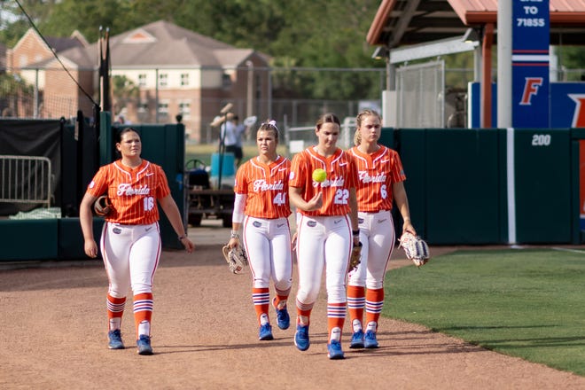 Florida Gators pitcher Elizabeth Hightower (22), Florida Gators pitcher Samantha Bender (6), Florida Gators pitcher Rylee Trlicek (44), and Florida Gators pitcher Lexie Delbrey (16) walk on the field before the game against the Auburn Tigers during the softball game at Katie Seashole Pressly Stadium at the University of Florida in Gainesville, FL on Thursday, April 6, 2023. [Matt Pendleton/Gainesville Sun]