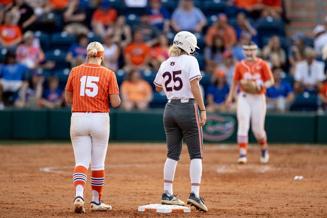 Florida Gators infielder Reagan Walsh (15) and Auburn Tigers outfielder Kenadie Cooper (25) stand next to each other during the game at Katie Seashole Pressly Stadium at the University of Florida in Gainesville, FL on Thursday, April 6, 2023. [Matt Pendleton/Gainesville Sun]