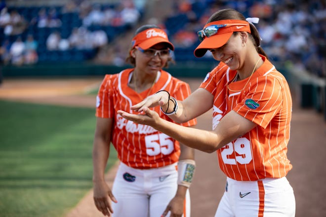 Florida Gators utility Pal Egan (55) and Florida Gators outfielder Katie Kistler (29) chomp for a video camera before the game against the Auburn Tigers at Katie Seashole Pressly Stadium at the University of Florida in Gainesville, FL on Thursday, April 6, 2023. [Matt Pendleton/Gainesville Sun]