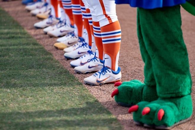 Alberta the Alligator and Florida Gators softball players shoes before the game against the Auburn Tigers at Katie Seashole Pressly Stadium at the University of Florida in Gainesville, FL on Thursday, April 6, 2023. [Matt Pendleton/Gainesville Sun]