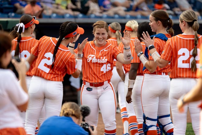 Florida Gators catcher Bryn Thomas (46) high fives as she is introduced before the game against the Auburn Tigers at Katie Seashole Pressly Stadium at the University of Florida in Gainesville, FL on Thursday, April 6, 2023. [Matt Pendleton/Gainesville Sun]