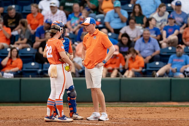 Florida Gators assistant coach Mike Bosch talks with Florida Gators pitcher Elizabeth Hightower (22) during the game against the Auburn Tigers at Katie Seashole Pressly Stadium at the University of Florida in Gainesville, FL on Thursday, April 6, 2023. [Matt Pendleton/Gainesville Sun]
