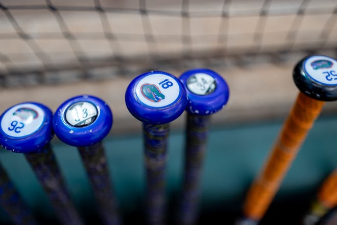 Softball bats lay against the fence before the game between the Florida Gators and Auburn Tigers during the softball game at Katie Seashole Pressly Stadium at the University of Florida in Gainesville, FL on Thursday, April 6, 2023. [Matt Pendleton/Gainesville Sun]