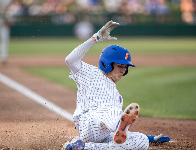 Florida's outfielder Michael Robertson (11) scores a run in the bottom of the sixth against Florida State University, Tuesday, April 11, 2023, at Condron Family Baseball Park in Gainesville, Florida. The Gators beat the Seminoles 5-3. [Cyndi Chambers/ Gainesville Sun] 2023
