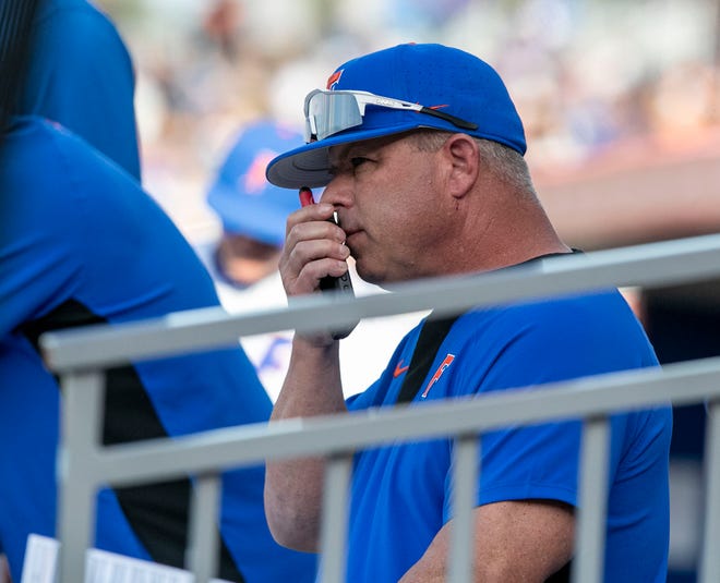 Florida head coach Kevin OÓ Sullivan calls in pitches from the dugout during the game against Florida State, Tuesday, April 11, 2023, at Condron Family Baseball Park in Gainesville, Florida. The Gators beat the Seminoles 5-3. [Cyndi Chambers/ Gainesville Sun] 2023