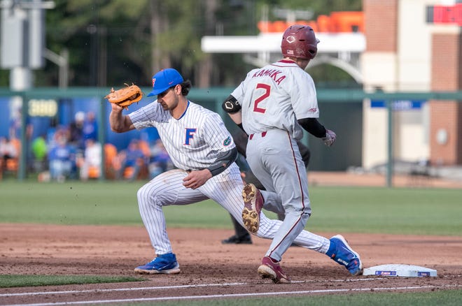 Florida's utility Jac Caglianone (14) with the catch at first for the out on Florida State's infielder Titan Kamaka (2) in the top of the fifth inning, Tuesday, April 11, 2023, at Condron Family Baseball Park in Gainesville, Florida. The Gators beat the Seminoles 5-3. [Cyndi Chambers/ Gainesville Sun] 2023