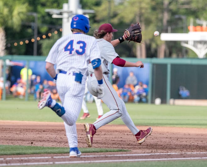 Florida State's utility Ben Barrett (33) with the out at first on Florida's outfielder Matt Prevesk (43), Tuesday, April 11, 2023, at Condron Family Baseball Park in Gainesville, Florida. The Gators beat the Seminoles 5-3. [Cyndi Chambers/ Gainesville Sun] 2023