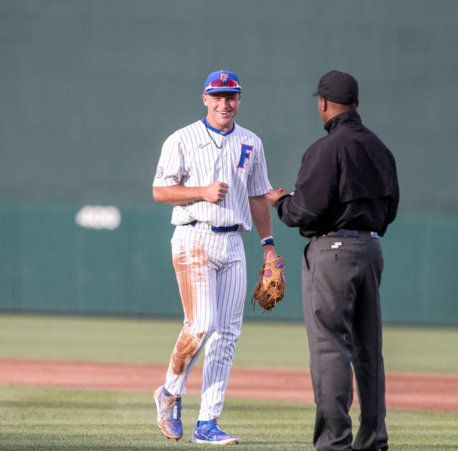 Florida's infielder Colby Halter (5) jokes with the first base umpire during the game against Florida State University, Tuesday, April 11, 2023, at Condron Family Baseball Park in Gainesville, Florida. The Gators beat the Seminoles 5-3. [Cyndi Chambers/ Gainesville Sun] 2023