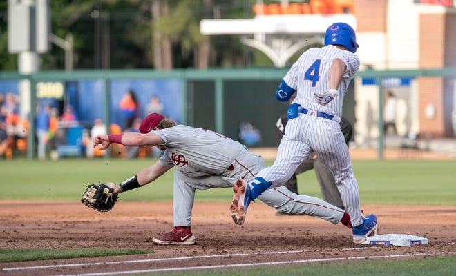 Florida State's James Tibbs III (22) stretches for the ball to get Florida's infielder Cade Kurland (4) out at first, Tuesday, April 11, 2023, at Condron Family Baseball Park in Gainesville, Florida. The Gators beat the Seminoles 5-3. [Cyndi Chambers/ Gainesville Sun] 2023