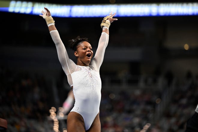 Apr 15, 2023; Fort Worth, TX, USA; University of Florida Gators gymnast Trinity Thomas celebrates after earning a perfect score on vault during the NCAA Women's National Gymnastics Tournament Championship at Dickies Arena. Mandatory Credit: Jerome Miron-USA TODAY Sports