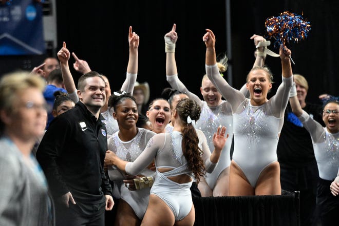 Apr 15, 2023; Fort Worth, TX, USA; University of Florida Gators gymnast Trinity Thomas and the Gators celebrates after Thomas earns a perfect score on vault during the NCAA Women's National Gymnastics Tournament Championship at Dickies Arena. Mandatory Credit: Jerome Miron-USA TODAY Sports