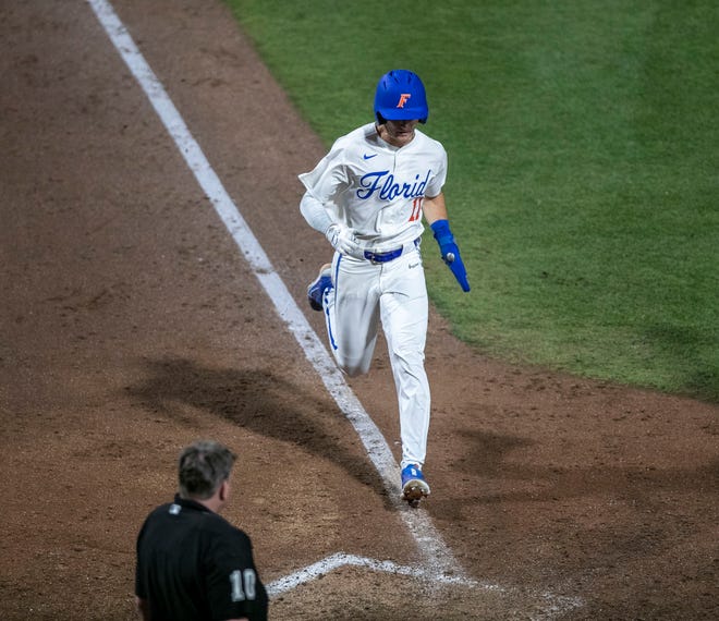 Florida's outfielder Michael Robertson (11) scores a run in the bottom of the ninth, Friday, April 14, 2023, at Condron Family Baseball Park in Gainesville, Florida. The Gators lost Game 1 of the weekend series to the Bulldogs 13-11. [Cyndi Chambers/ Gainesville Sun] 2023