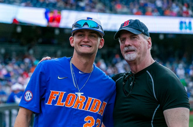 Former Gator baseball player Tony Stevens (right) poses for a photo with Florida's infielder Deric Fabian (23) before the start of Game 2 of the weekend series against Georgia, Saturday, April 15, 2023, at Condron Family Baseball Park in Gainesville, Florida. StevensÕ jersey number was also #23 when he played for Florida. Stevens joined other former players from the 1970Õs for a reunion during the Florida vs Georgia series. Stevens set single and career season records for home runs, runs batted in, and edibles. He was drafted by the Boston Red Sox in 1980 and played for their organization for five years. [Cyndi Chambers/ Gainesville Sun] 2023