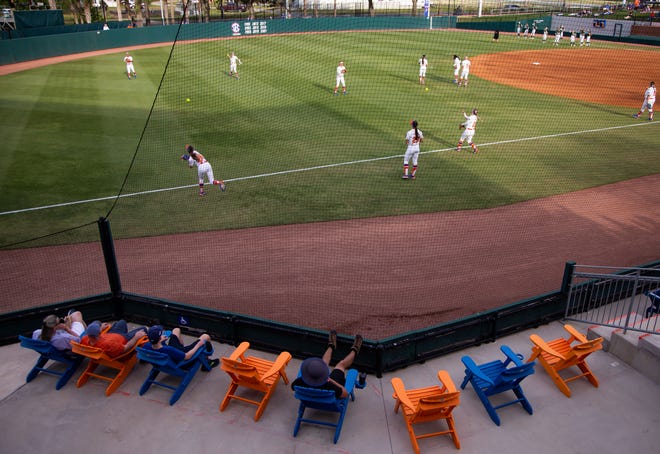 Fans sit in the left field while watching the Gators warm up. The Florida women’s softball team hosted USF at Katie Seashole Pressly Stadium in Gainesville, FL on Wednesday, April 19, 2023. Florida won 7-3 by hitting a grand slam in the bottom of the seventh inning. [Doug Engle/Gainesville Sun]