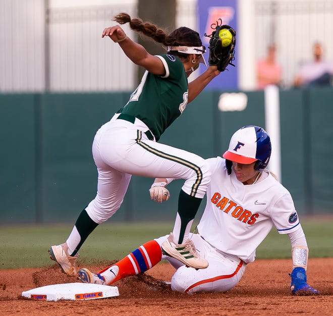 Florida infielder Skylar Wallace (17) steals second in the bottom of the first as South Fla. infielder Kathy Garcia (21) gets ball late. The Florida women’s softball team hosted USF at Katie Seashole Pressly Stadium in Gainesville, FL on Wednesday, April 19, 2023. Florida won 7-3 by hitting a grand slam in the bottom of the seventh inning. [Doug Engle/Gainesville Sun]