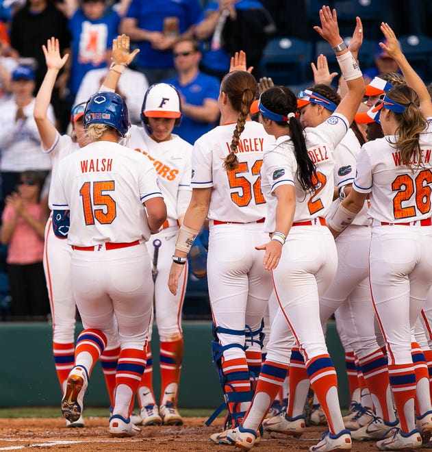Florida infielder Reagan Walsh (15) is greeted at home plate after hitting a home run in the bottom of the first making 2-0. The Florida women’s softball team hosted USF at Katie Seashole Pressly Stadium in Gainesville, FL on Wednesday, April 19, 2023. Florida won 7-3 by hitting a grand slam in the bottom of the seventh inning. [Doug Engle/Gainesville Sun]