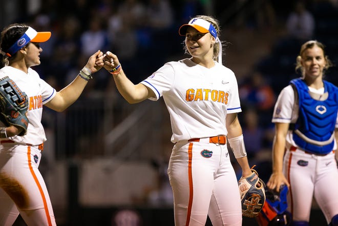 Florida utility Emily Wilkie (18) gets a fist bump from a teammate after closing out the top of the seventh. The Florida women’s softball team hosted USF at Katie Seashole Pressly Stadium in Gainesville, FL on Wednesday, April 19, 2023. Florida won 7-3 by hitting a grand slam in the bottom of the seventh inning. [Doug Engle/Gainesville Sun]