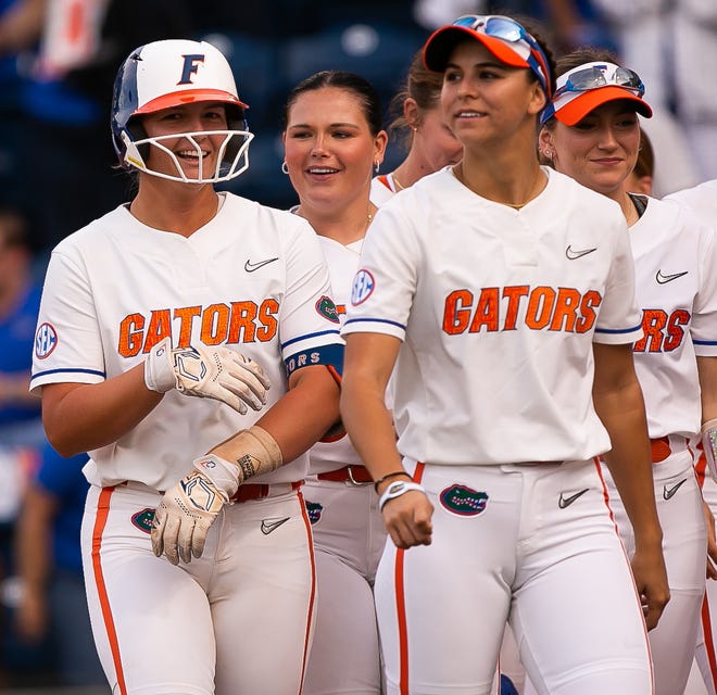 Florida infielder Reagan Walsh (15), left,  is greeted at home plate after hitting a home run in the bottom of the first making 2-0. The Florida women’s softball team hosted USF at Katie Seashole Pressly Stadium in Gainesville, FL on Wednesday, April 19, 2023. Florida won 7-3 by hitting a grand slam in the bottom of the seventh inning. [Doug Engle/Gainesville Sun]