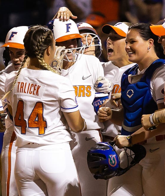 Florida utility Emily Wilkie (18) center, is mobbed by her teammates after hitting a grand slam in the bottom of the seventh to win the game 7-3. The Florida women’s softball team hosted USF at Katie Seashole Pressly Stadium in Gainesville, FL on Wednesday, April 19, 2023. Florida won 7-3 by hitting a grand slam in the bottom of the seventh inning. [Doug Engle/Gainesville Sun]The Florida women’s softball team hosted USF at Katie Seashole Pressly Stadium in Gainesville, FL on Wednesday, April 19, 2023. Florida won 7-3 by hitting a grand slam in the bottom of the seventh inning. [Doug Engle/Gainesville Sun]