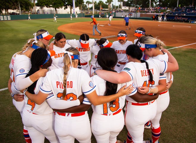 The Florida Gators have a prayer before the start of the game against USF. The Florida women’s softball team hosted USF at Katie Seashole Pressly Stadium in Gainesville, FL on Wednesday, April 19, 2023. Florida won 7-3 by hitting a grand slam in the bottom of the seventh inning. [Doug Engle/Gainesville Sun]