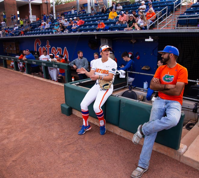 Florida outfielder Kaila Pollard (23), left, talks with Groundskeeper Cody Fiol before the start of the game. The Florida women’s softball team hosted USF at Katie Seashole Pressly Stadium in Gainesville, FL on Wednesday, April 19, 2023. Florida won 7-3 by hitting a grand slam in the bottom of the seventh inning. [Doug Engle/Gainesville Sun]