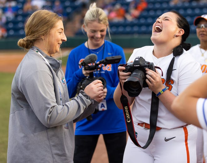 Florida starting pitcher/relief pitcher Lexie Delbrey (16) laughs while taking pictures of her teammates. The Florida women’s softball team hosted USF at Katie Seashole Pressly Stadium in Gainesville, FL on Wednesday, April 19, 2023. Florida won 7-3 by hitting a grand slam in the bottom of the seventh inning. [Doug Engle/Gainesville Sun]