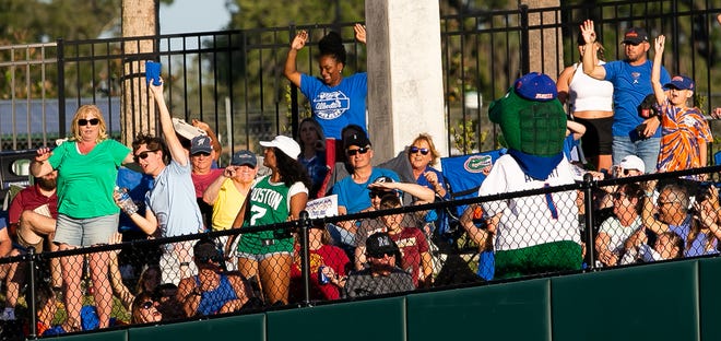 Florida fans grab thrown t-shirts by Albert the Alligator between innings. The Florida women’s softball team hosted FSU at Katie Seashole Pressly Stadium in Gainesville, FL on Wednesday, May 3, 2023. The Seminoles defeated the Gators 8-7.  [Doug Engle/Gainesville Sun]