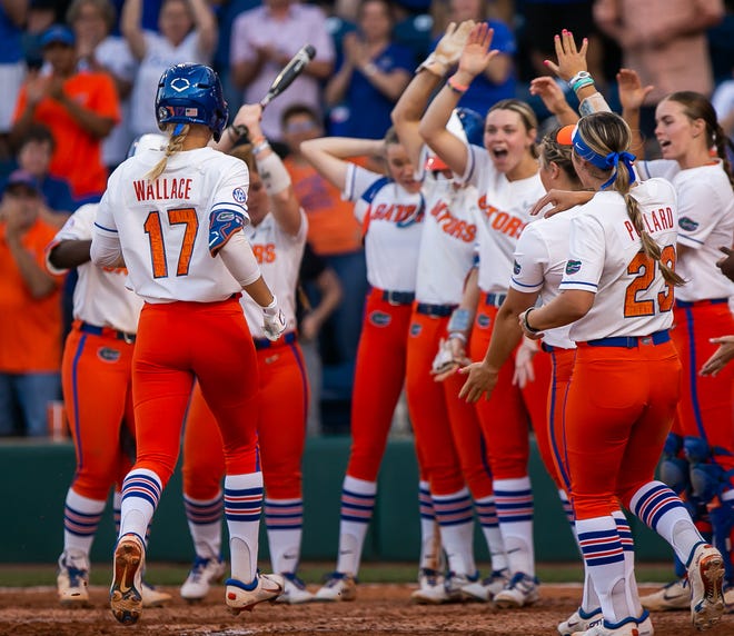 Florida Gators infielder Skylar Wallace (17) is greeted at home plate by teammates after hitting a home run in the bottom of the fourth to go ahead of the Seminoles 4-3. The Florida women’s softball team hosted FSU at Katie Seashole Pressly Stadium in Gainesville, FL on Wednesday, May 3, 2023. The Seminoles defeated the Gators 8-7.  [Doug Engle/Gainesville Sun]