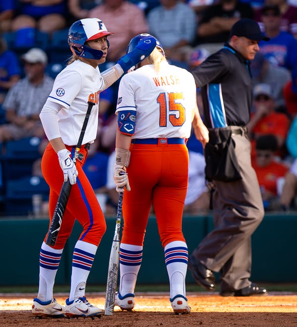 Florida Gators infielder Skylar Wallace (17) scores a run in the first inning while encouraging teammate Florida Gators infielder Reagan Walsh (15) as she went to bat. The Florida women’s softball team hosted FSU at Katie Seashole Pressly Stadium in Gainesville, FL on Wednesday, May 3, 2023. The Seminoles defeated the Gators 8-7.  [Doug Engle/Gainesville Sun]