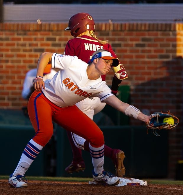 Florida Gators starting pitcher Samantha Bender (6) safe at first in top of the fourth as Florida Gators utility Emily Wilkie (18) gets the ball late. The Florida women’s softball team hosted FSU at Katie Seashole Pressly Stadium in Gainesville, FL on Wednesday, May 3, 2023. The Seminoles defeated the Gators 8-7.  [Doug Engle/Gainesville Sun]