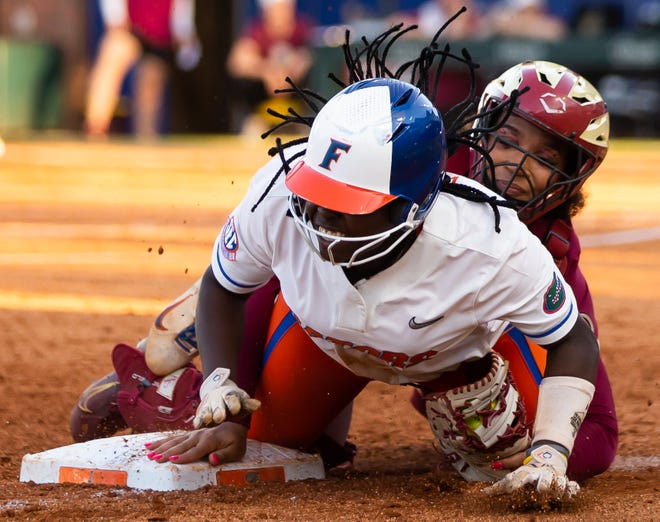 Florida Gators third baseman Charla Echols (4) gets safely back to third after getting caught in a rundown with Florida St. Seminoles catcher Michaela Edenfield (51) in the 3rd inning. The Florida women’s softball team hosted FSU at Katie Seashole Pressly Stadium in Gainesville, FL on Wednesday, May 3, 2023. The Seminoles defeated the Gators 8-7.  [Doug Engle/Gainesville Sun]