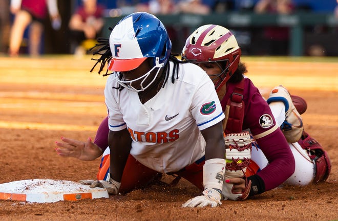 Florida Gators third baseman Charla Echols (4) gets safely back to third after getting caught in a rundown with Florida St. Seminoles catcher Michaela Edenfield (51) in the 3rd inning. The Florida women’s softball team hosted FSU at Katie Seashole Pressly Stadium in Gainesville, FL on Wednesday, May 3, 2023. The Seminoles defeated the Gators 8-7.  [Doug Engle/Gainesville Sun]